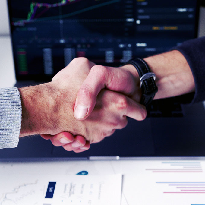 Handshake Over Laptop